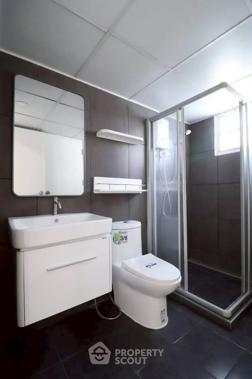 Modern bathroom with sleek fixtures and glass shower enclosure