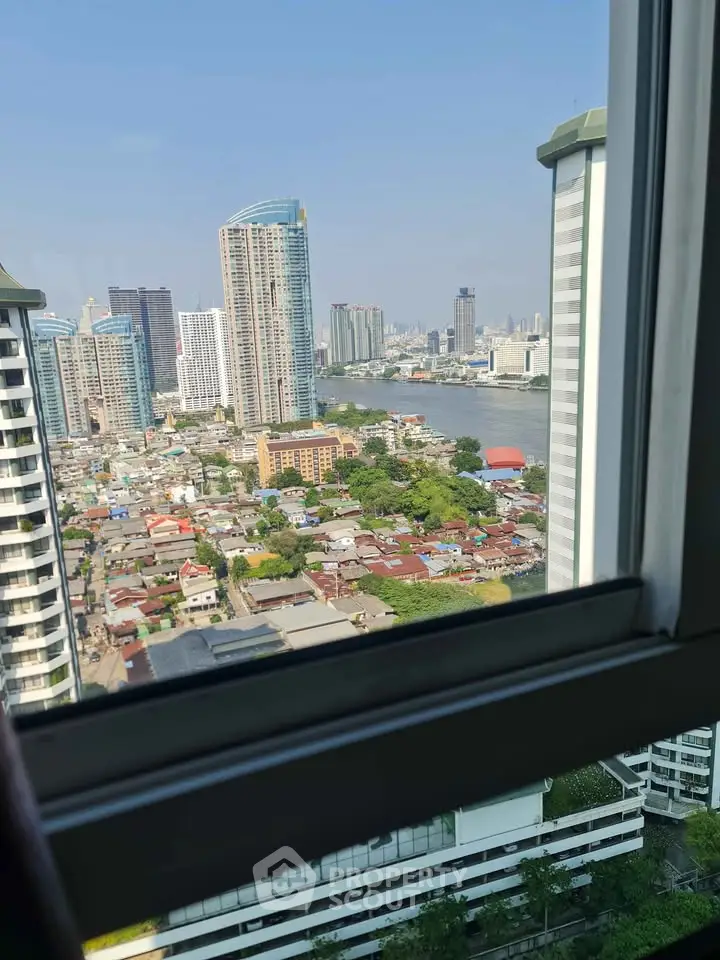 Stunning cityscape view from high-rise window overlooking river and skyline.