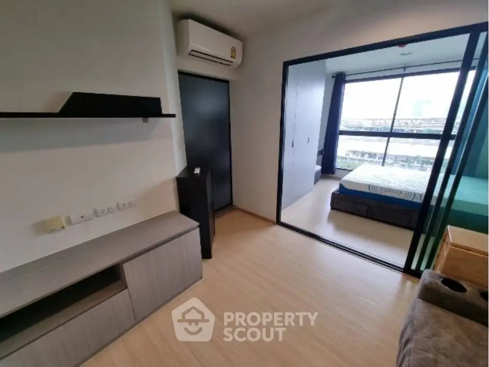 Modern apartment interior with sliding glass doors and city view