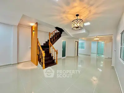 Spacious modern living room with elegant staircase and stylish lighting
