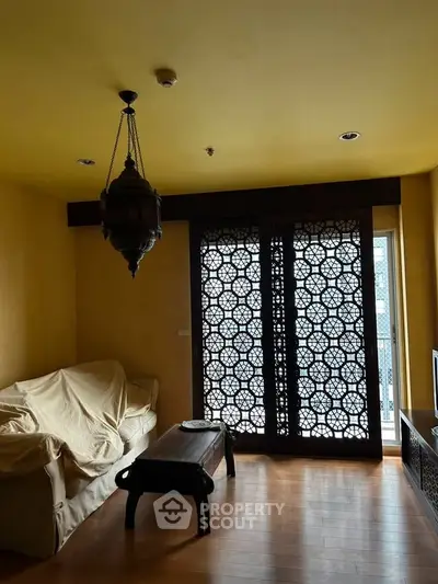 Charming living room with intricate wooden screen and cozy seating area.