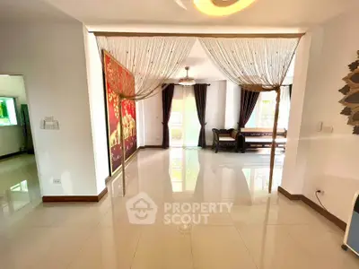 Spacious living room with elegant curtains and bright natural light