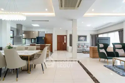 Spacious open-plan living and dining area with modern furnishings and elegant decor.