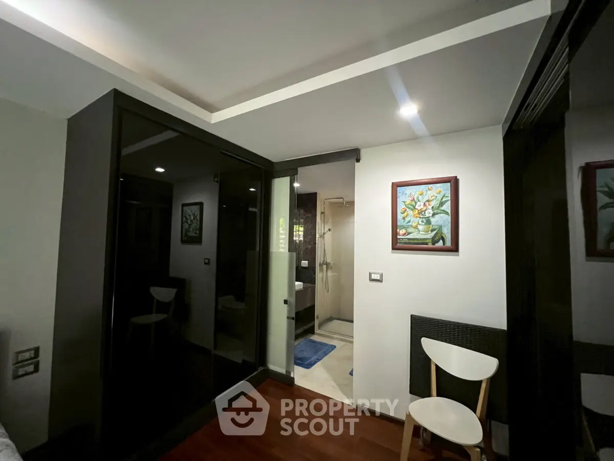 Modern interior with sleek design, featuring a stylish bathroom entrance and elegant decor.
