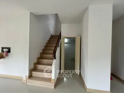 Modern interior with wooden staircase and white walls, ideal for stylish home design.