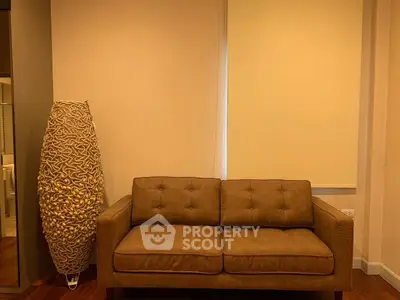 Cozy living room with stylish brown sofa and unique floor lamp