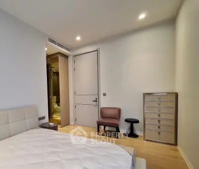 Modern bedroom with ensuite bathroom, featuring elegant furniture and soft lighting for a cozy ambiance.