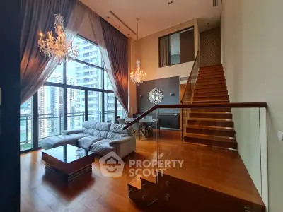 Luxurious duplex living room with high ceilings, chandeliers, and city view
