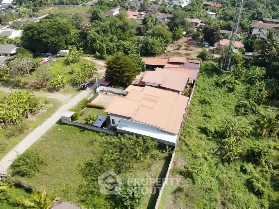 Aerial view of spacious countryside property with lush greenery and expansive land