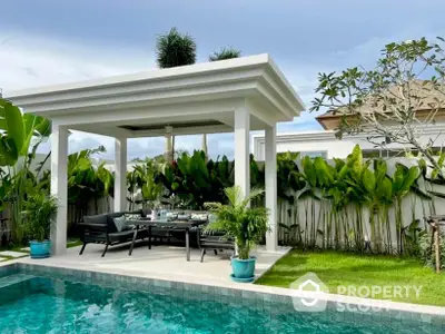 Luxurious outdoor pool area with modern gazebo and lush greenery