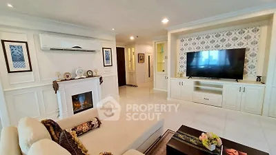 Luxurious living room with elegant decor, fireplace, and large TV in a modern apartment.