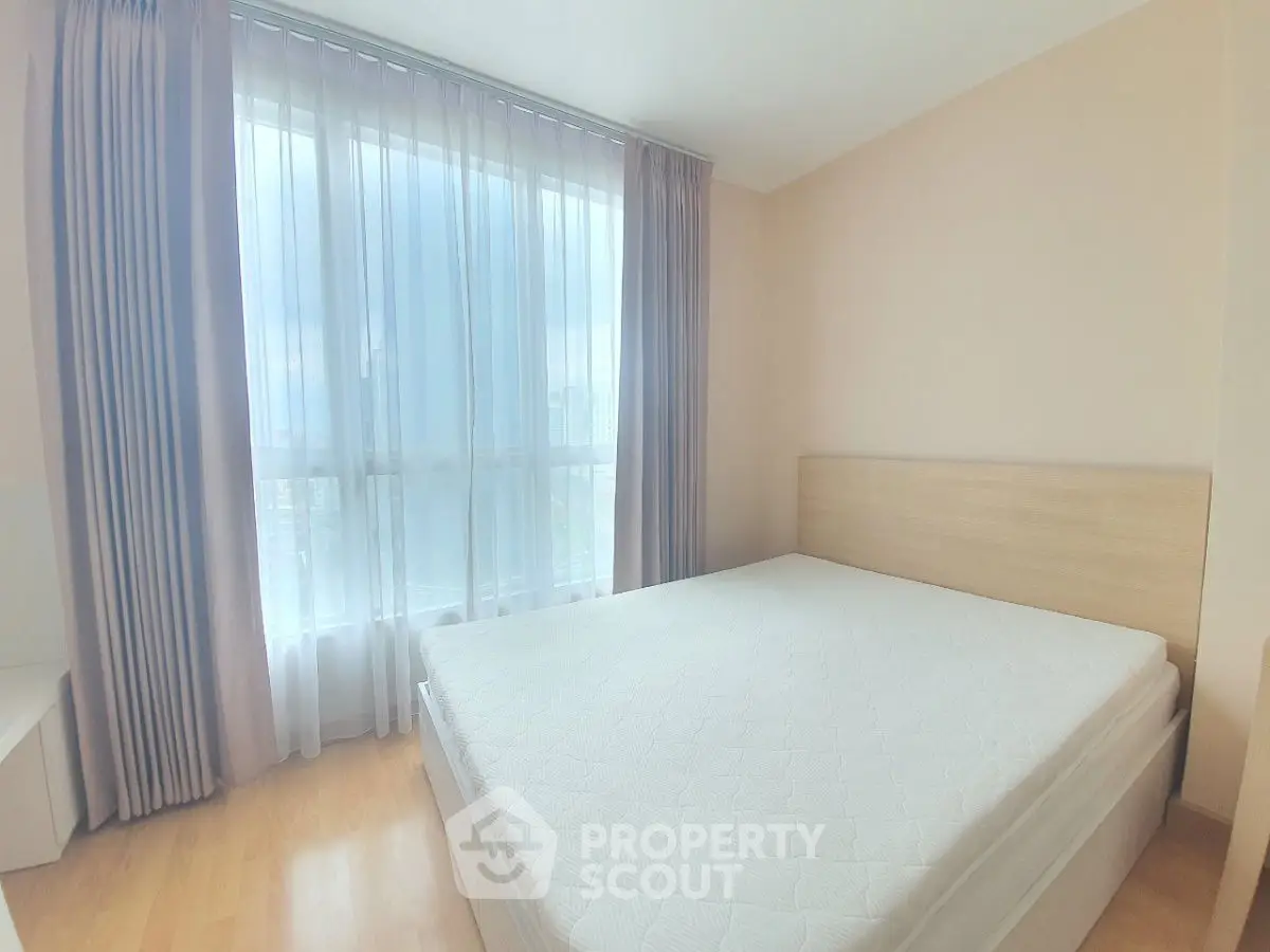 Bright bedroom with large window and minimalist decor
