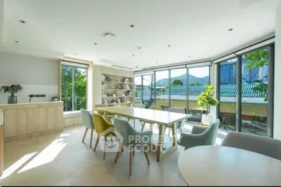 Bright and spacious dining area with large windows and modern decor