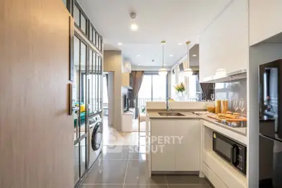 Modern open-layout kitchen with sleek appliances and bright living area