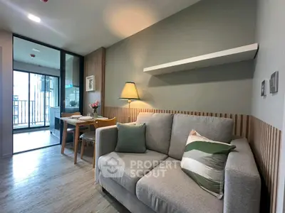 Modern living room with cozy sofa and dining area, featuring stylish decor and balcony access.