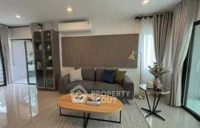 Modern living room with stylish decor, cozy sofa, and elegant lighting in a bright, airy space.