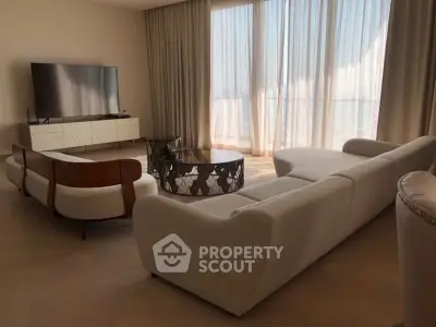 Luxurious living room with modern furniture and large windows offering abundant natural light.