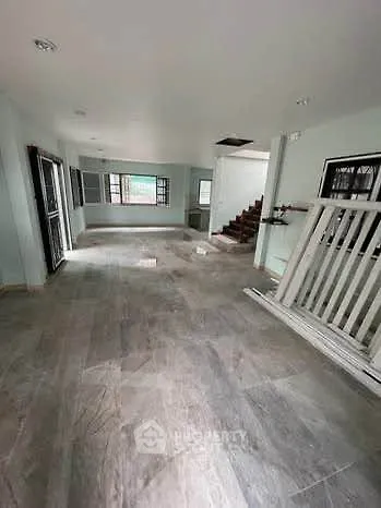 Spacious open-plan living area with modern flooring and natural light, ideal for family gatherings.