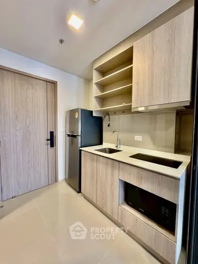 Modern kitchen with sleek cabinetry and built-in appliances in a stylish apartment.