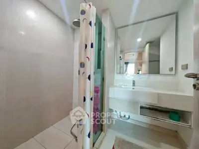 Spacious bathroom with modern shower and large mirror