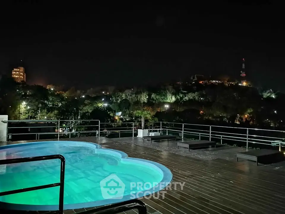 Stunning rooftop pool with panoramic night view of cityscape