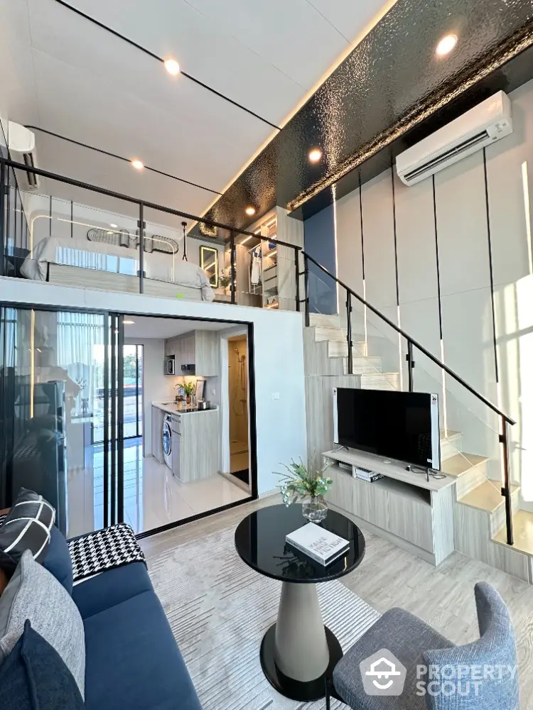 Modern loft apartment with stylish interior, featuring open layout living room and kitchen, mezzanine bedroom.