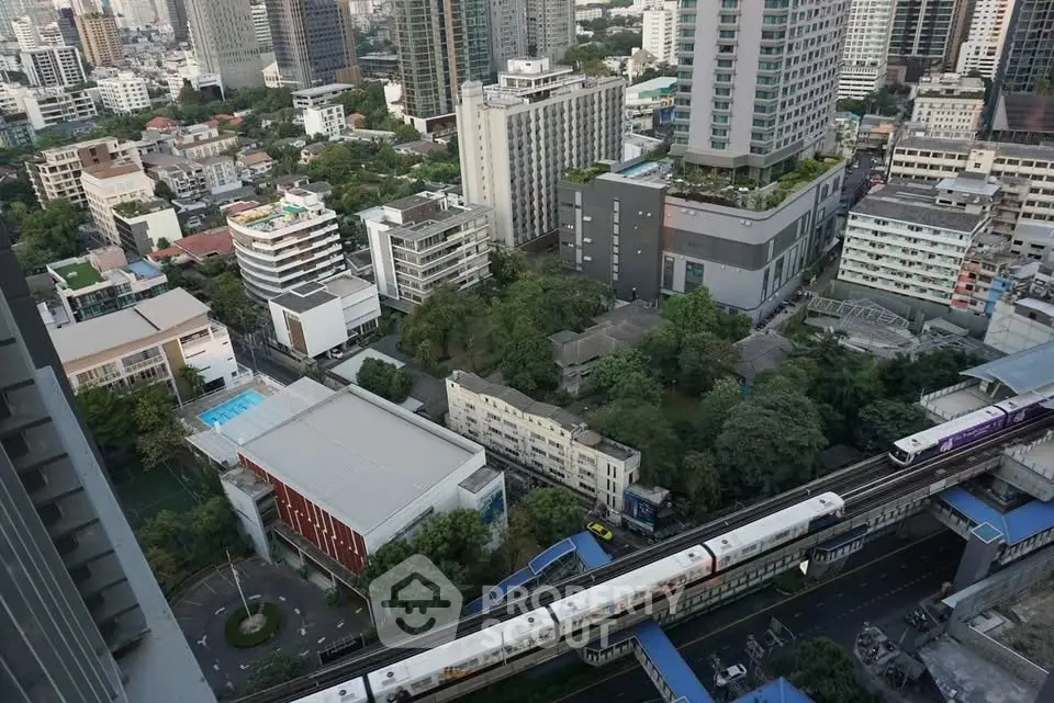 Stunning aerial view of urban skyline with modern high-rise buildings and lush greenery.