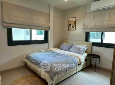 Cozy bedroom with modern decor and natural light, featuring a comfortable bed and stylish window treatments.