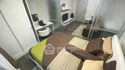 Modern bedroom with stylish decor and workspace, featuring sleek furniture and neutral tones.