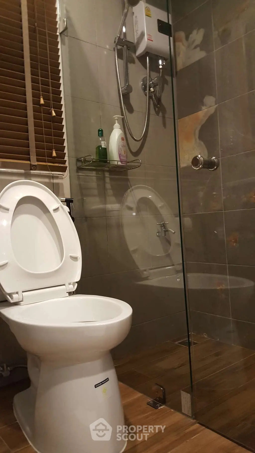 Modern bathroom with glass shower and wooden flooring
