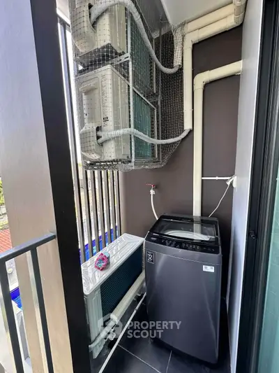 Modern balcony with washing machine and air conditioning units