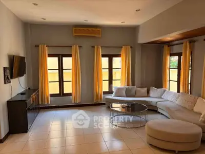 Spacious living room with modern decor and large windows for natural light.