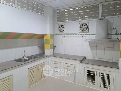 Spacious kitchen with modern appliances and ample storage space.