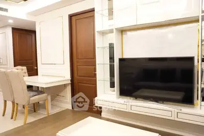 Modern living room with elegant dining area and sleek TV setup