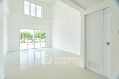 Spacious modern living room with high ceilings and large windows