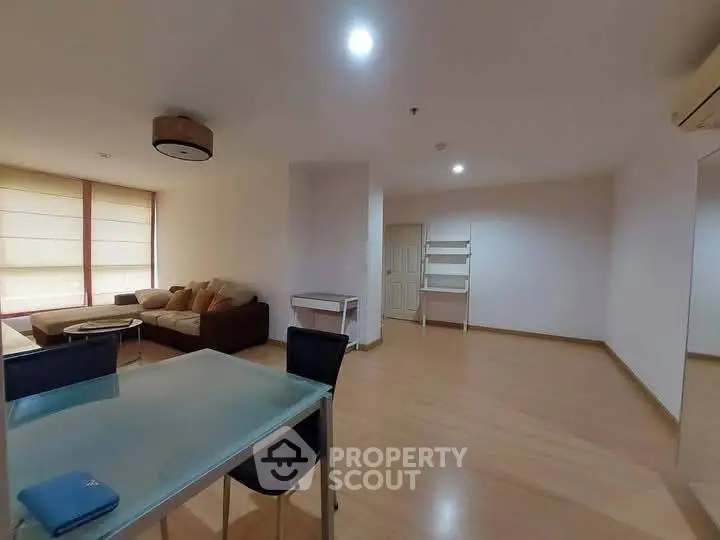 Spacious living room with modern furniture and ample natural light