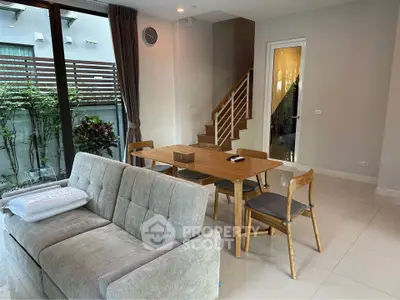 Modern living room with stylish furniture and garden view