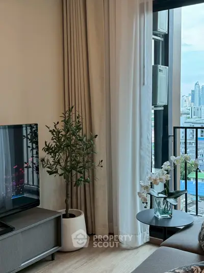 Modern living room with city view, featuring stylish decor and large windows.