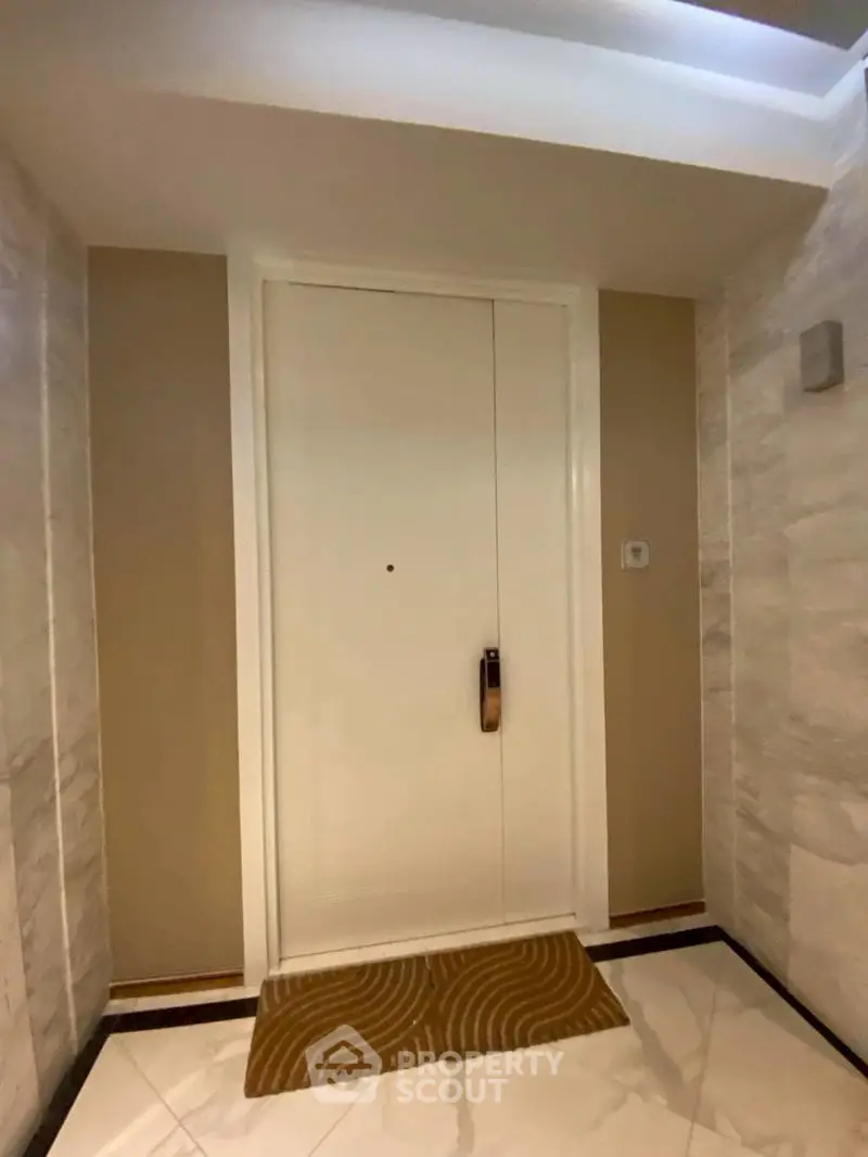 Elegant apartment entrance with modern door and stylish flooring