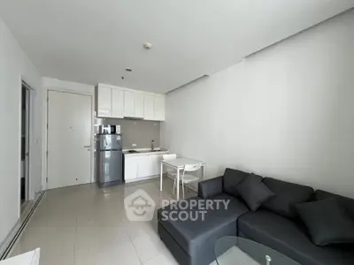 Modern apartment living room with sleek kitchen and cozy sofa