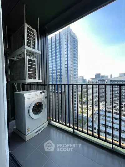 High-rise balcony with washing machine and cityscape view, perfect for urban living.
