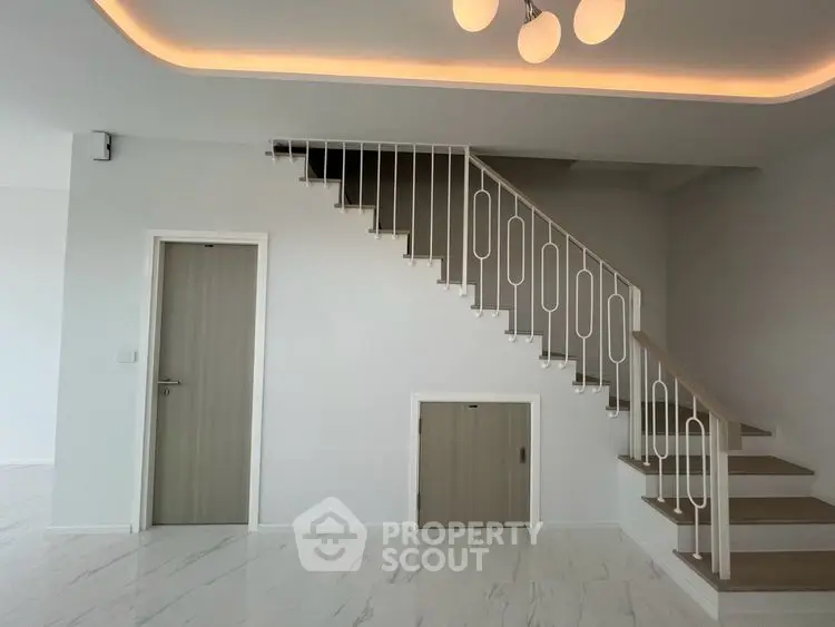 Modern interior with elegant staircase and sleek lighting