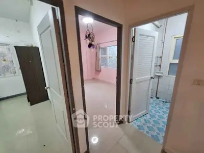 Spacious apartment interior with tiled floors and multiple rooms, ideal for comfortable living.