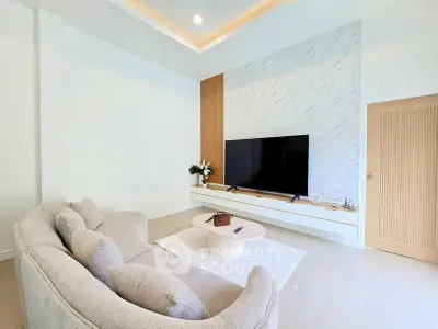 Modern living room with sleek TV setup and cozy beige sofa