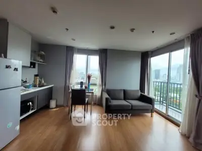 Modern living room with city view, featuring a cozy sofa and dining area, perfect for urban living.