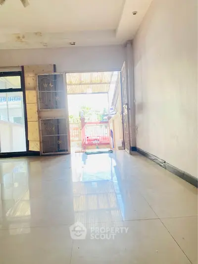 Spacious living room with large windows and bright natural light