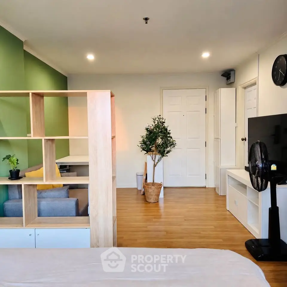 Modern living room with stylish partition and green accent wall