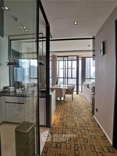 Modern apartment interior with open layout and city view, featuring stylish kitchen and spacious living area.