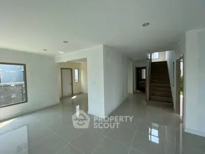 Spacious modern interior with glossy tiled floors and natural light