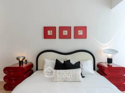 Stylish bedroom with modern red nightstands and elegant lighting
